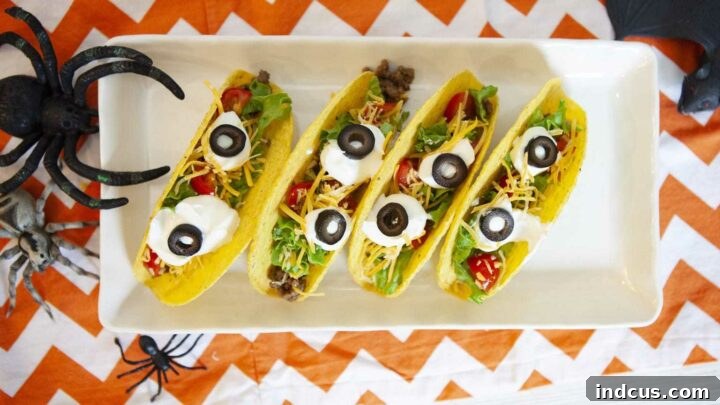Tacos decorated with sour cream and olive eyeballs.
