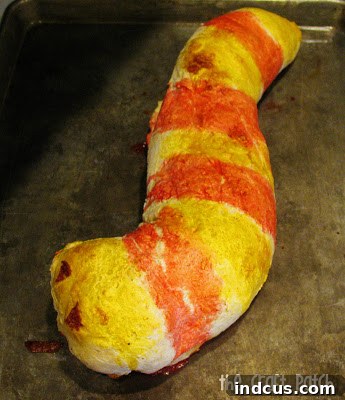A pizza snake or stromboli in the shape of a snake.