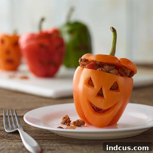 Jack-O-Lantern stuffed peppers filled with taco turkey.