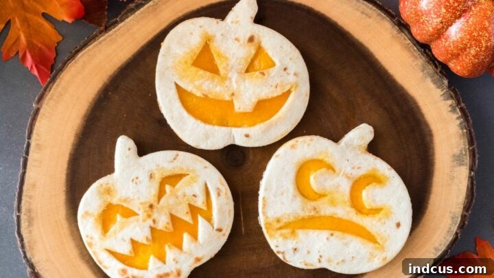 Jack-O-Lantern quesadillas with cheese filling.