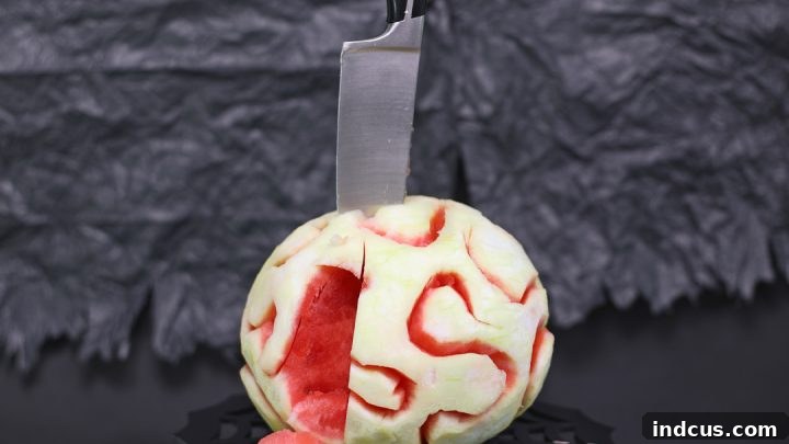 Watermelon carved and shaped to resemble a zombie brain.