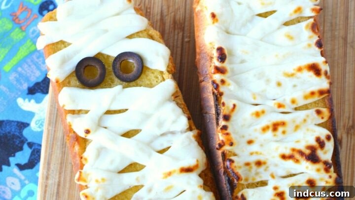 Mummy garlic bread made from breadsticks wrapped in cheese.