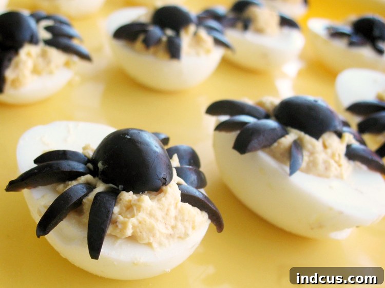 Deviled eggs topped with black olive spiders.