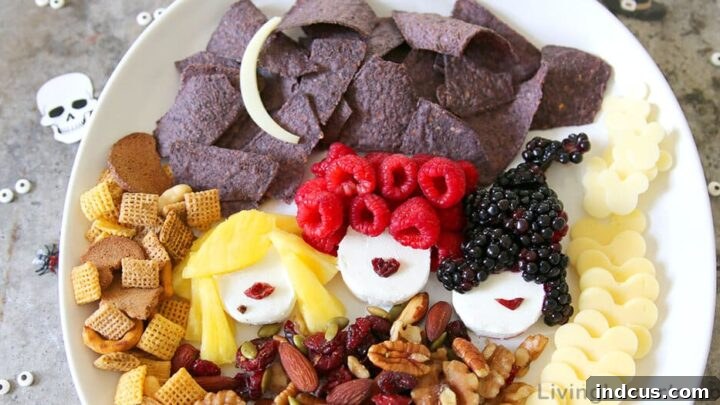 Hocus Pocus themed charcuterie board with fruits, cheeses, and themed decorations.