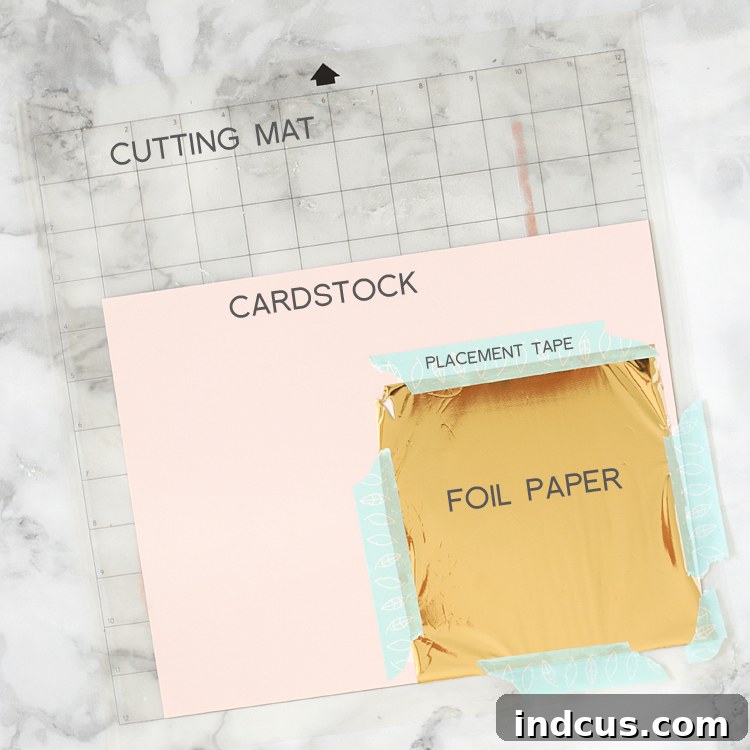 Image showing foil taped over cardstock on a Silhouette cutting mat, ready for foiling.