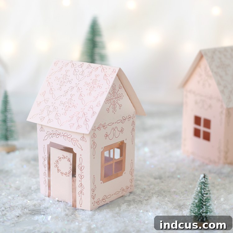 DIY paper Christmas houses featuring beautiful gold foil and metallic vinyl accents around windows and doors.