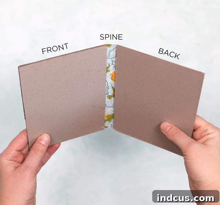 Chipboard covers being glued to the spine, showing the 1/2 inch gap.