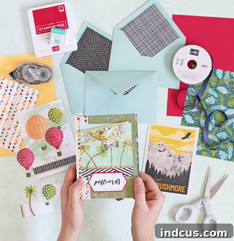 Finished envelope book with decorative elements and postcard visible in a pocket.
