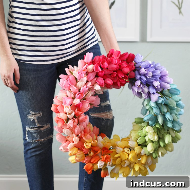 Vibrant rainbow tulip wreath on a light-colored door, perfect for spring decor