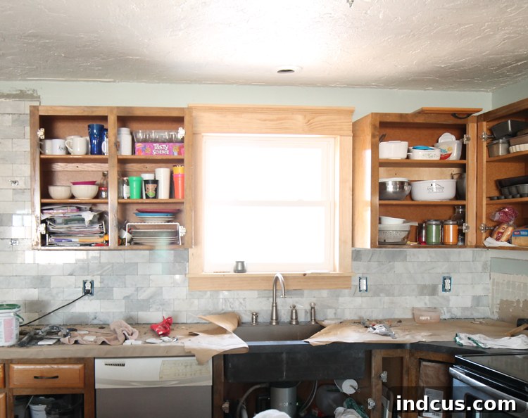 Kitchen cabinets before extending to the ceiling and adding crown molding, showing a gap above