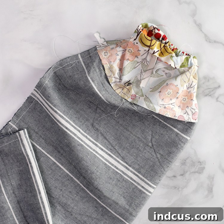 Grocery bag holder with elasticized bottom for easy bag retrieval