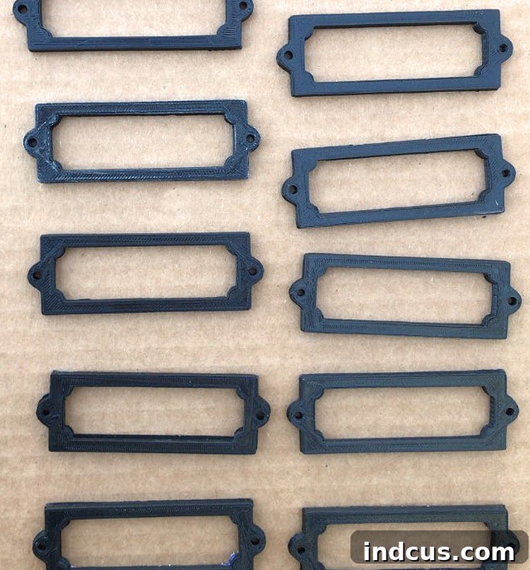 Customizable 3D Printed Labels 7 Freshly 3D printed label holders in black PLA filament, before any painting or finishing