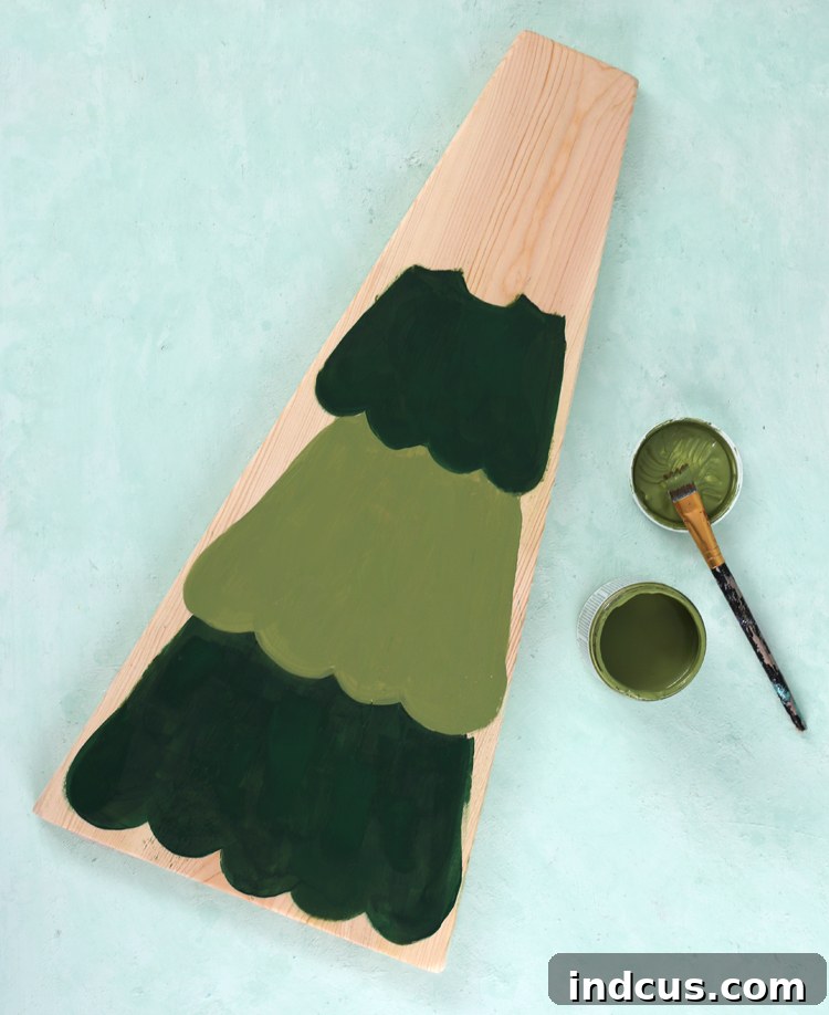 Painted Christmas tree on the reverse side of the wood sign