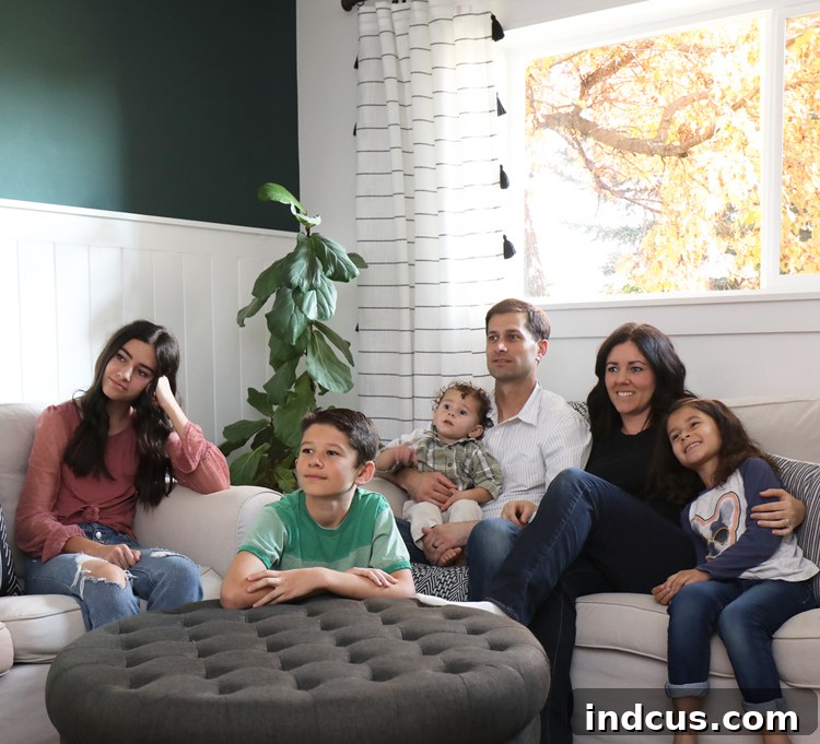 Family gathered on a couch, watching TV together, symbolizing meaningful family time.