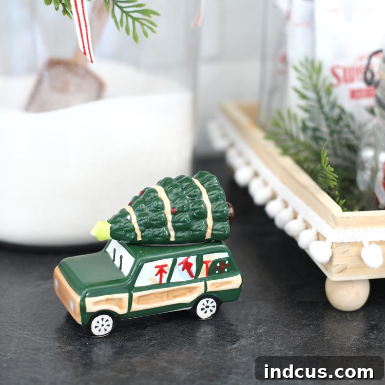 Yuletide Charm: Inside Festive Homes 12 Cute green Christmas car salt and pepper shaker on a kitchen counter.