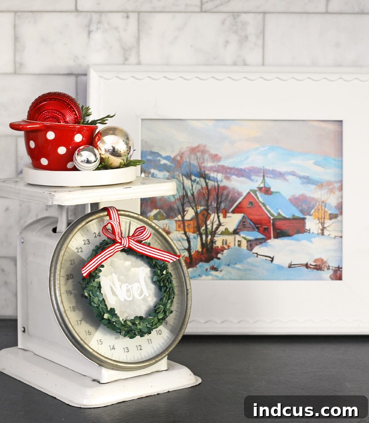Yuletide Charm: Inside Festive Homes 14 Christmas kitchen vignette featuring a vintage scale, red measuring cup with ornaments, and a small wreath.