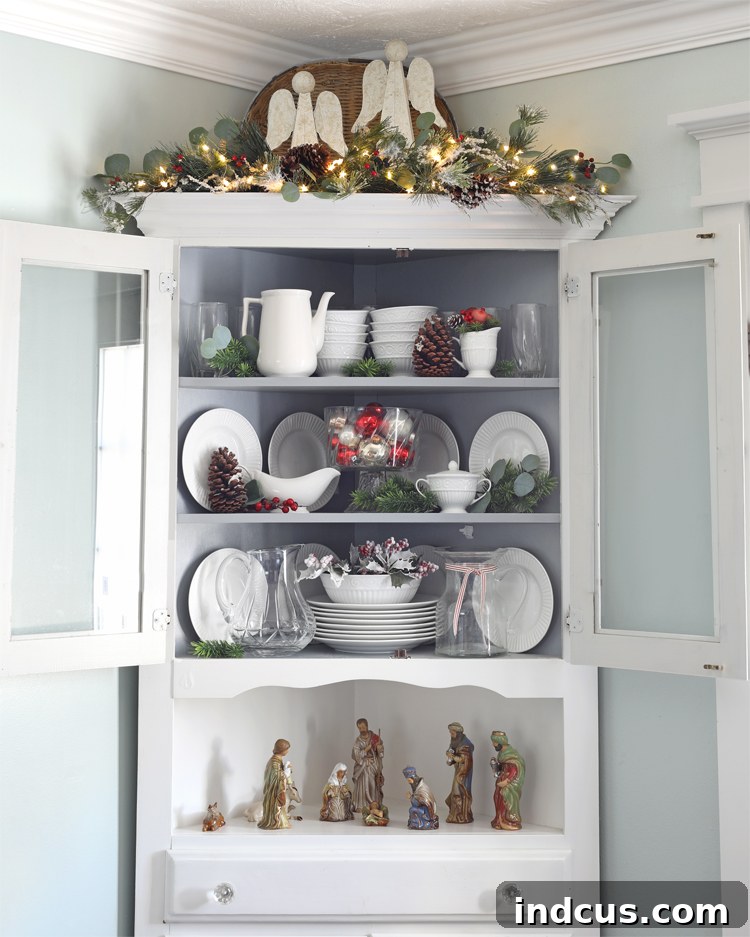 Yuletide Charm: Inside Festive Homes 15 Corner hutch decorated for Christmas with a nativity set and festive touches.