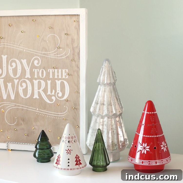 Yuletide Charm: Inside Festive Homes 18 Collection of glass and ceramic Christmas trees of various sizes and styles, creating a charming display.