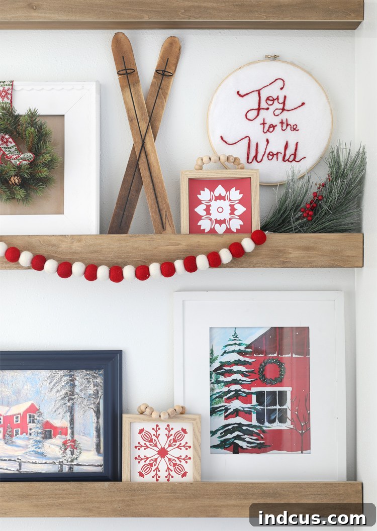 Yuletide Charm: Inside Festive Homes 20 Close-up of photo ledges decorated for Christmas, featuring festive artwork and Scandinavian snowflake accents.