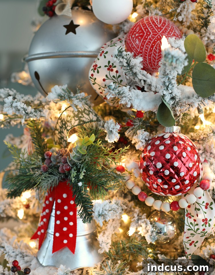 Yuletide Charm: Inside Festive Homes 6 Detail shot of Christmas tree with silver bells, wood bead garland, and festive lighting.