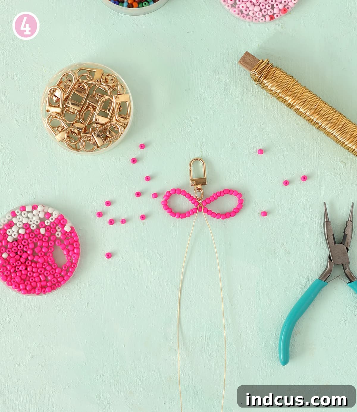Handcraft Charming Beaded Bow Keychains 7 Looping jewelry wire around a keychain clasp to shape a bow