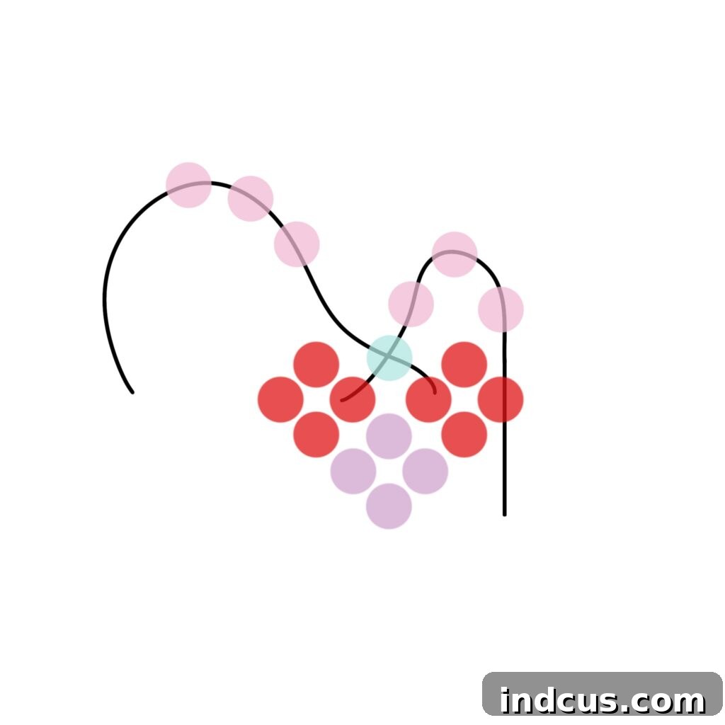 DIY Sparkling Beaded Heart Charms 11 Step 7 details how to add beads and loop wire to create the signature curved top of the beaded heart.