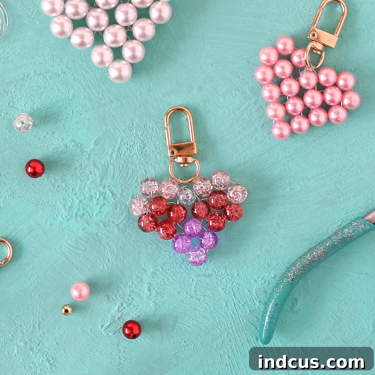 DIY Sparkling Beaded Heart Charms 13 Final step of the DIY beaded heart tutorial: attaching jewelry hardware and trimming excess wire.