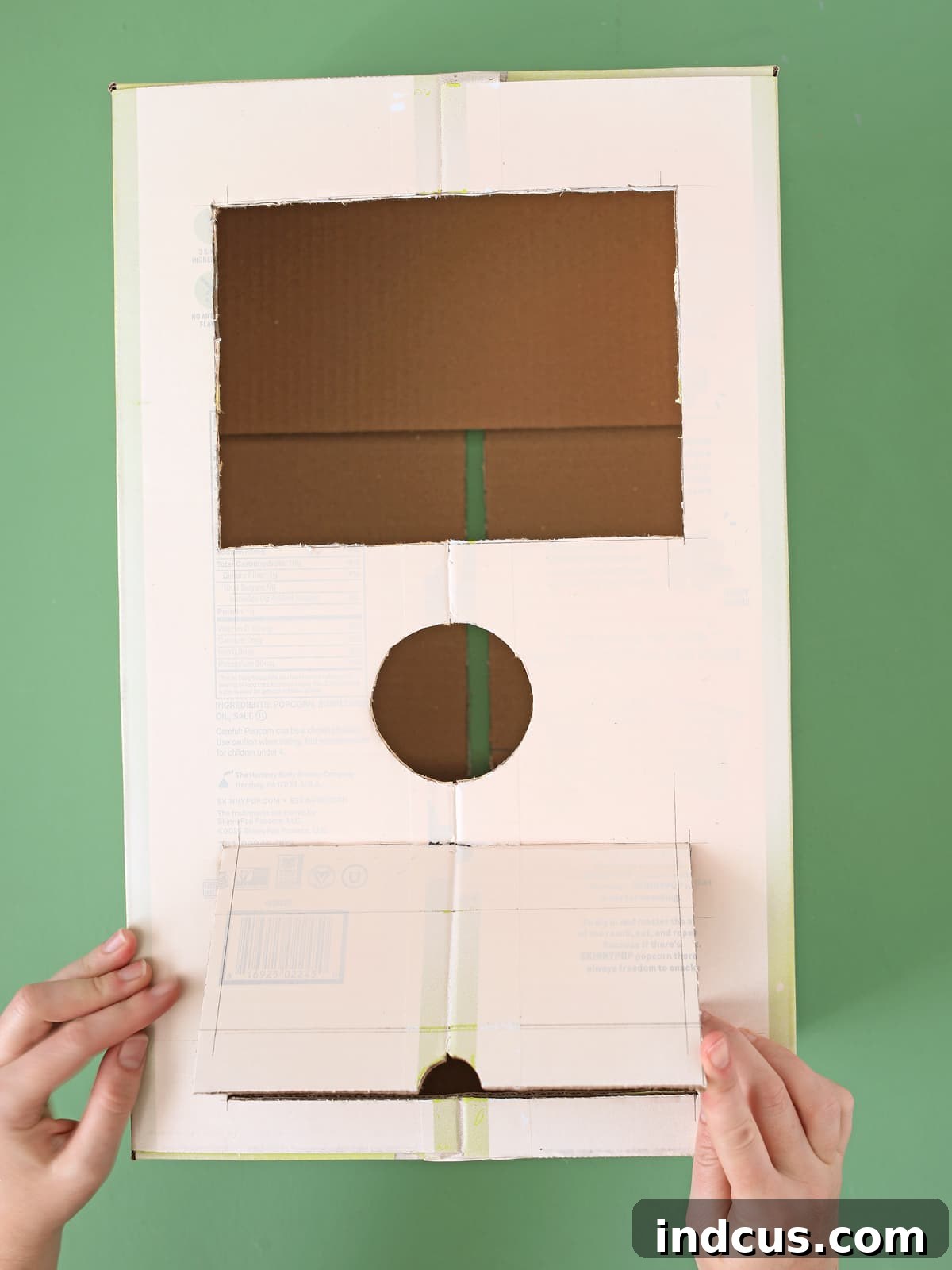Handcrafted Party Prize Surprise 4 Illustrative image showing cuts for window, circle, and prize flap on a cardboard box.